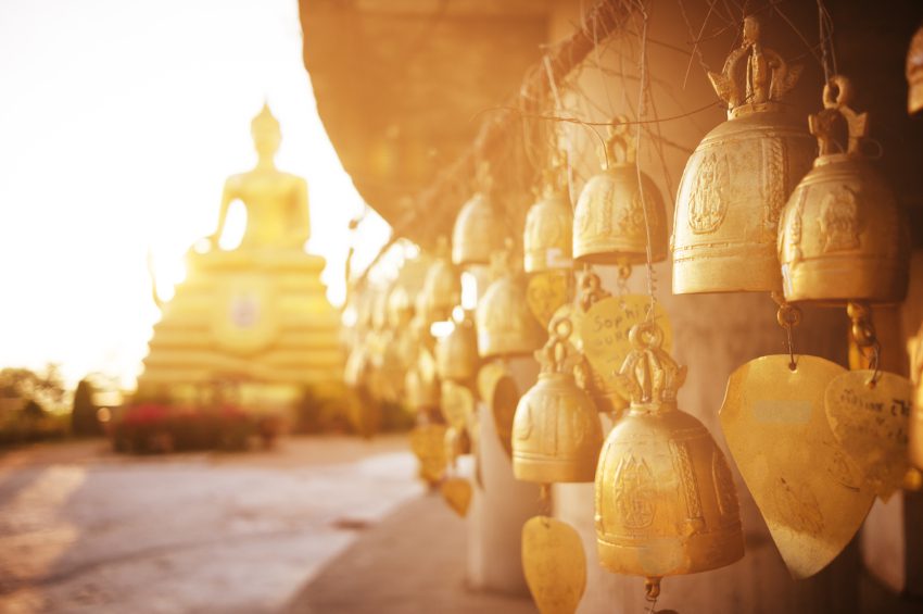 Sitting Buddha and buddhist bells