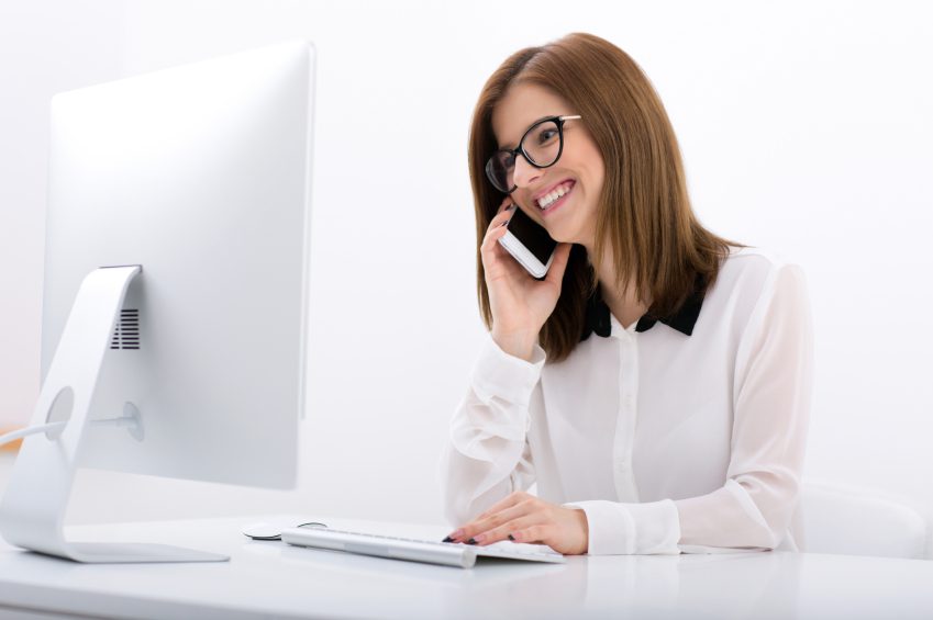 Happy businesswoman in glasses working in office